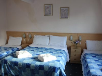The Brooklyn Hotel family of 4 room one double bed and two single beds with blue bedding