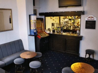 The Brooklyn Hotel bar area with a fruit machine and a seating area
